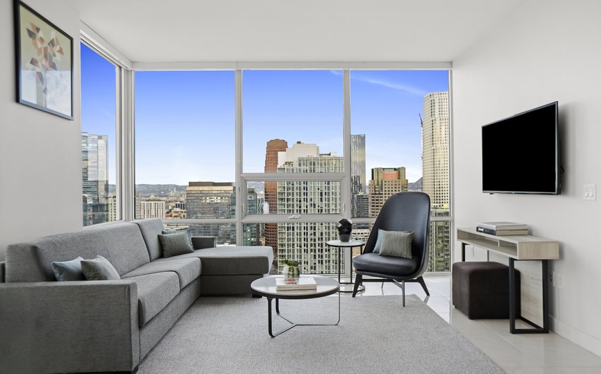 living room with a view of the LA skyline in a two bedroom suite at Level Los Angeles South Olive