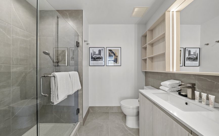 modern spacious bathroom featuring standing shower and malin goetz amenity at level fulton market chicago