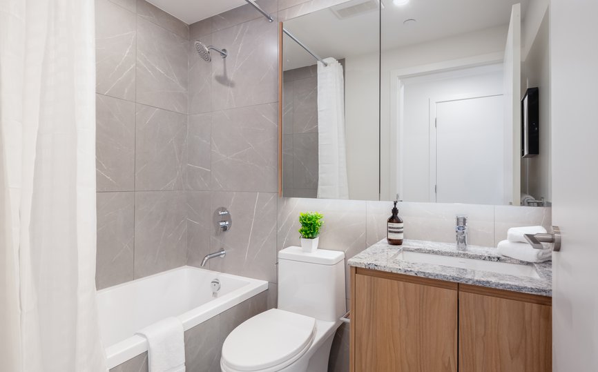 modern bathroom in rental two bedroom furnished apartment with bath tub