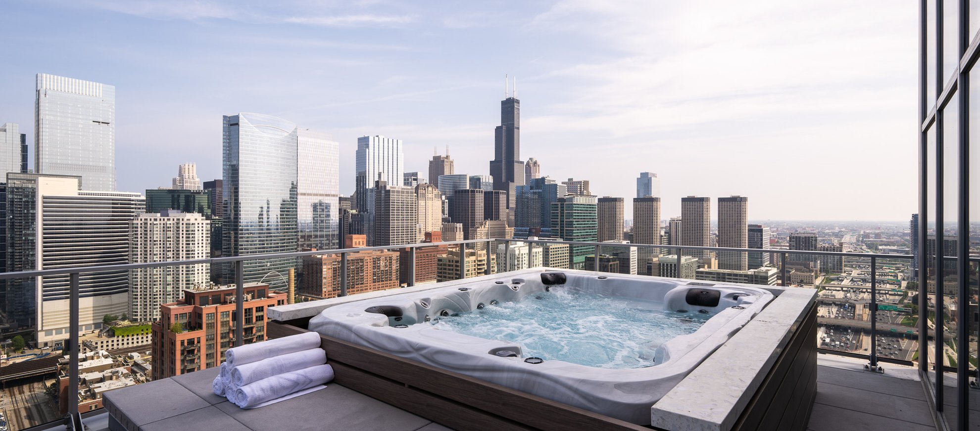 outdoor hot tub at the penthouse level chicago fulton market with chicago skyline view