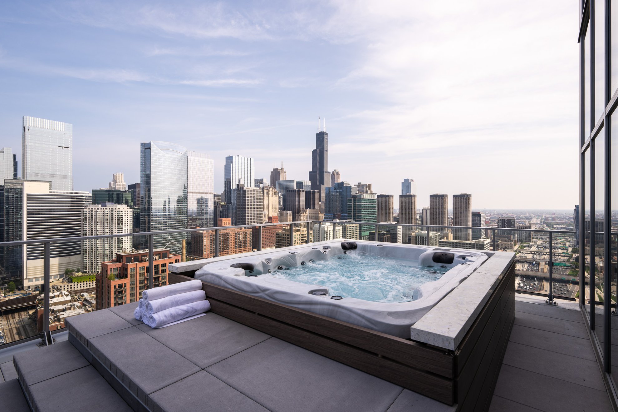 outdoor hot tub at the penthouse level chicago fulton market with chicago skyline view