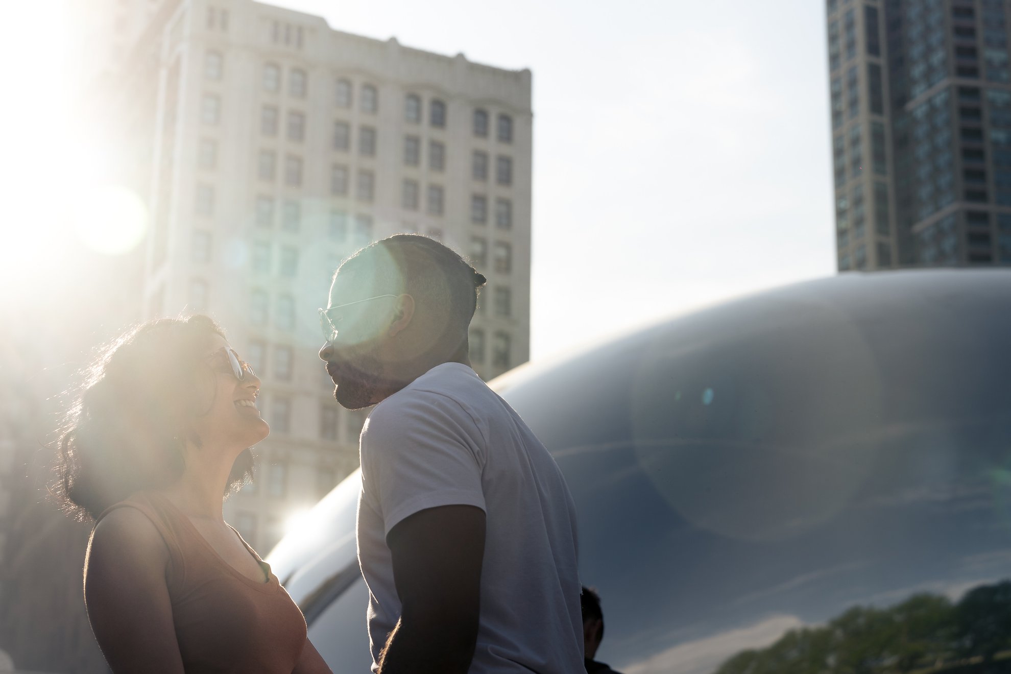 couple looking at each other outside the bean statue in chicago