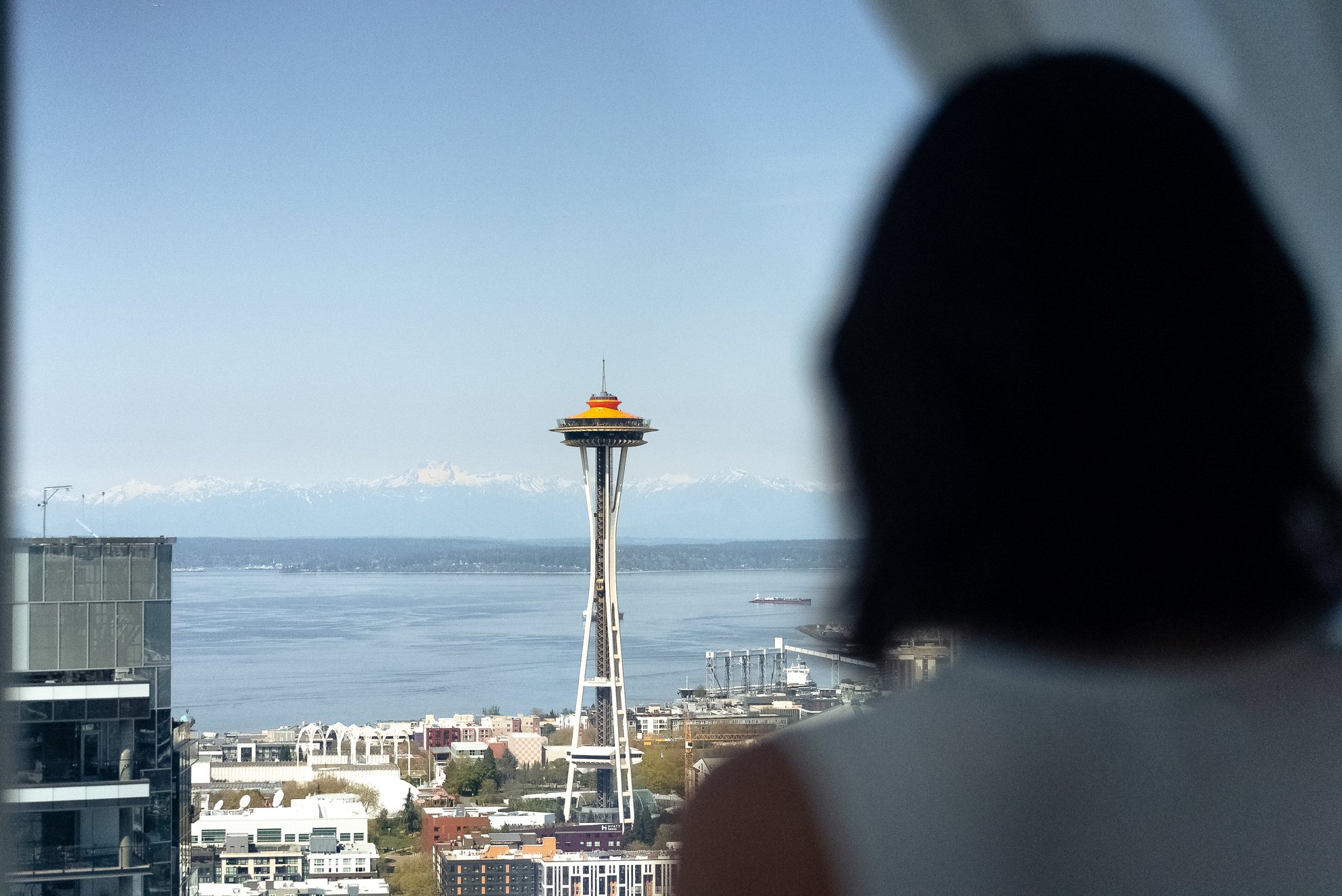 girl looking outside at the view of the downtown seattle