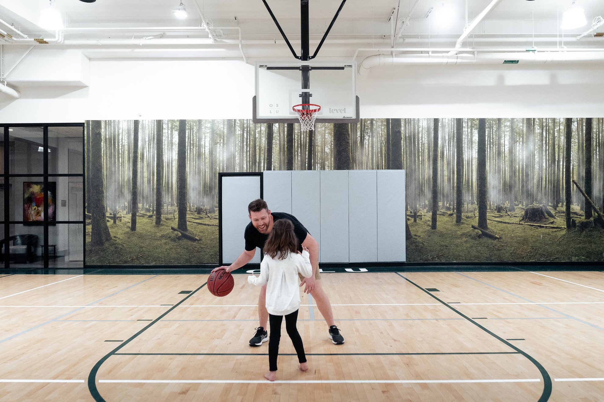 dad and little girl playing basketball together