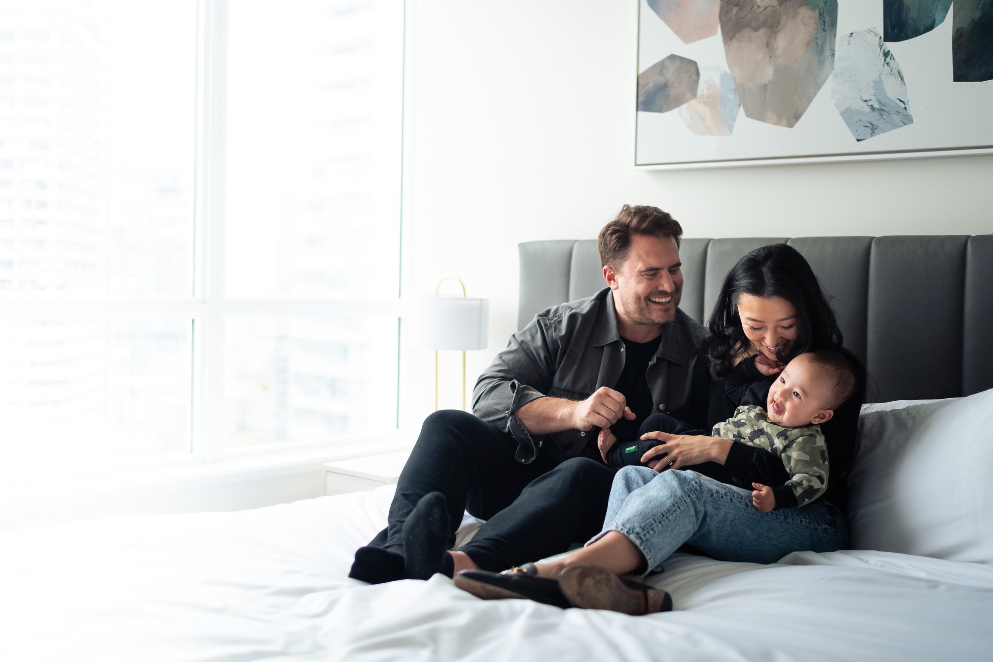 family portrait in bedroom furnished suite at level port moody