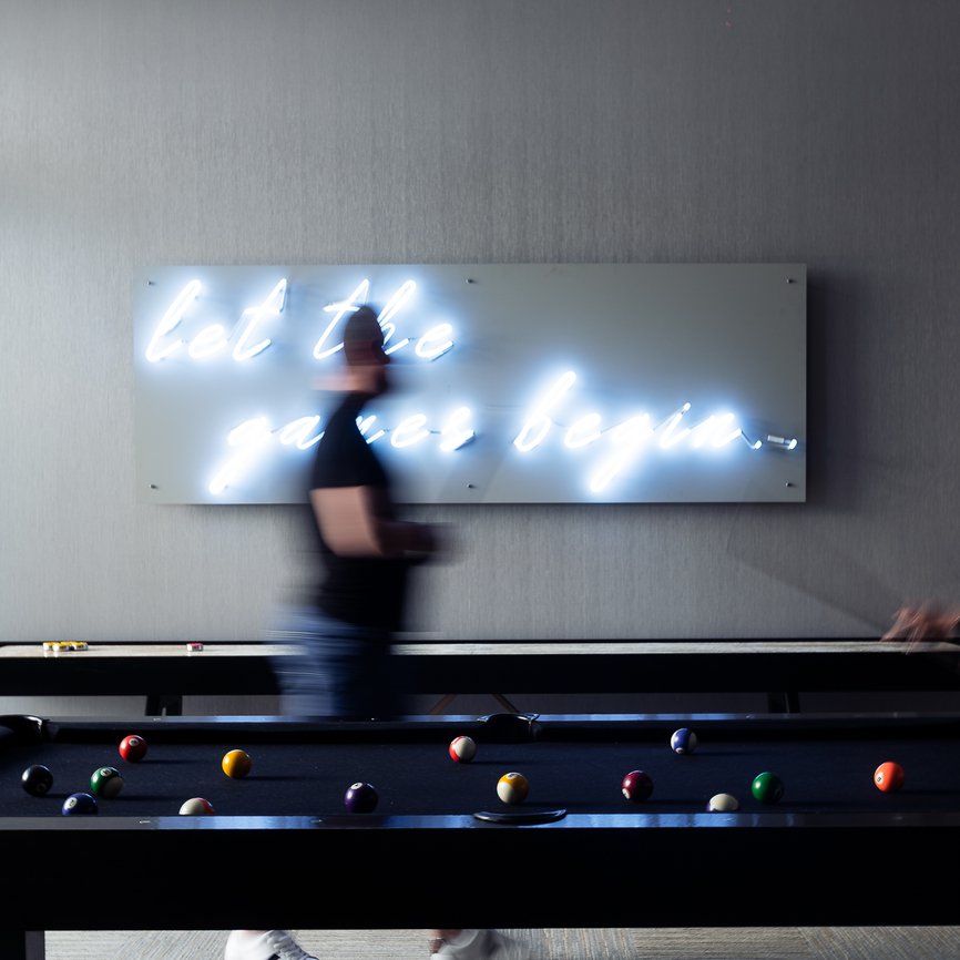 couple playing billiard in the game room