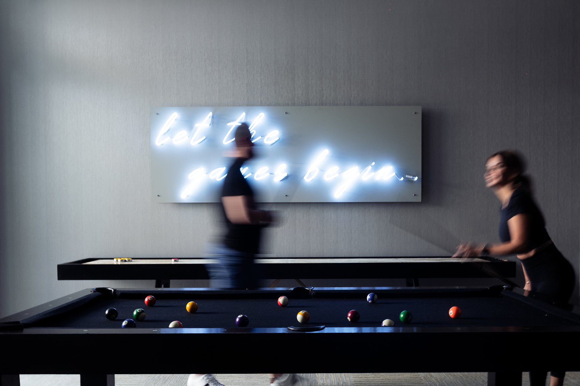 couple playing billiard in the game room