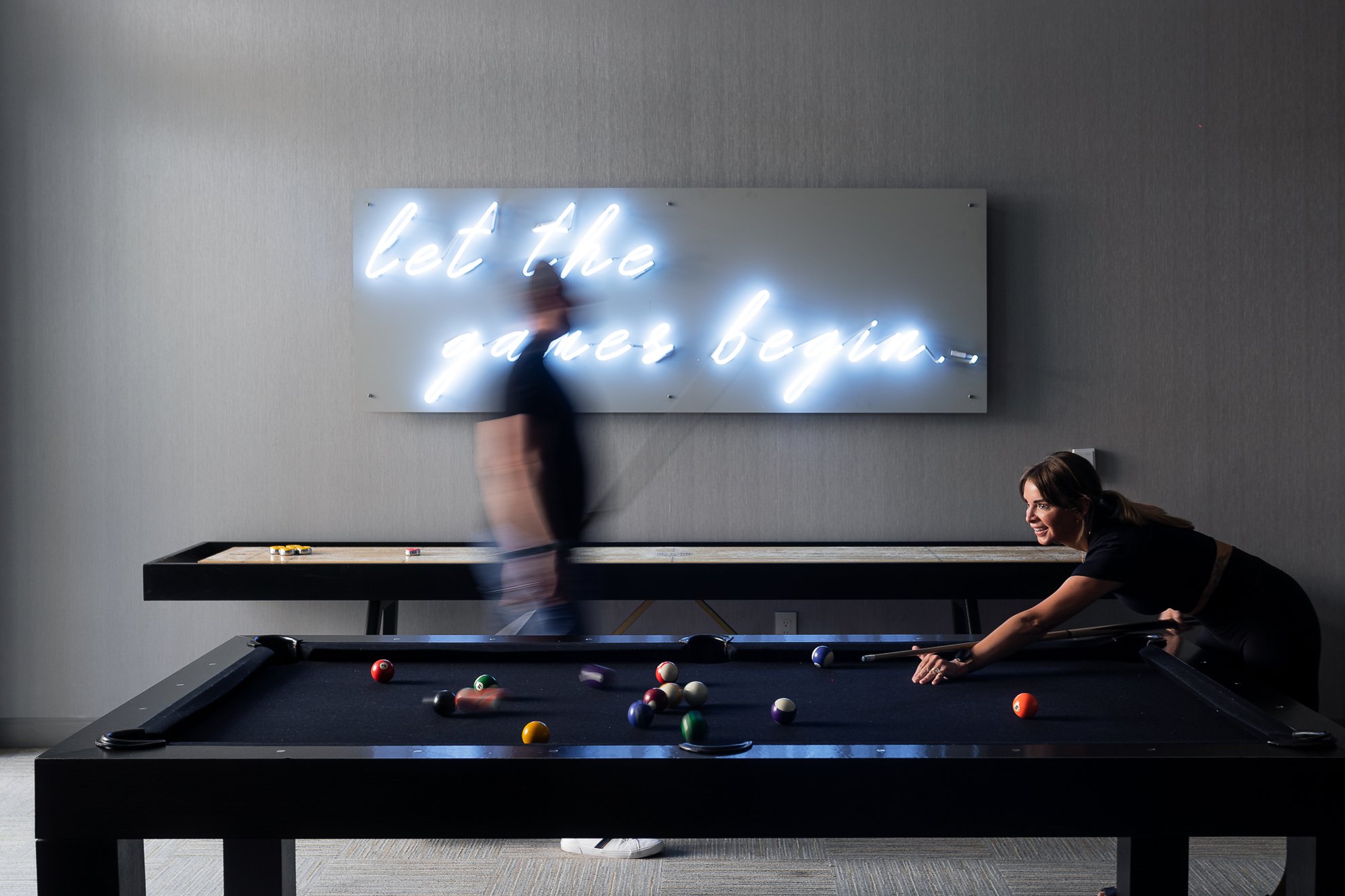 couple playing pool in the entertaining lounge space