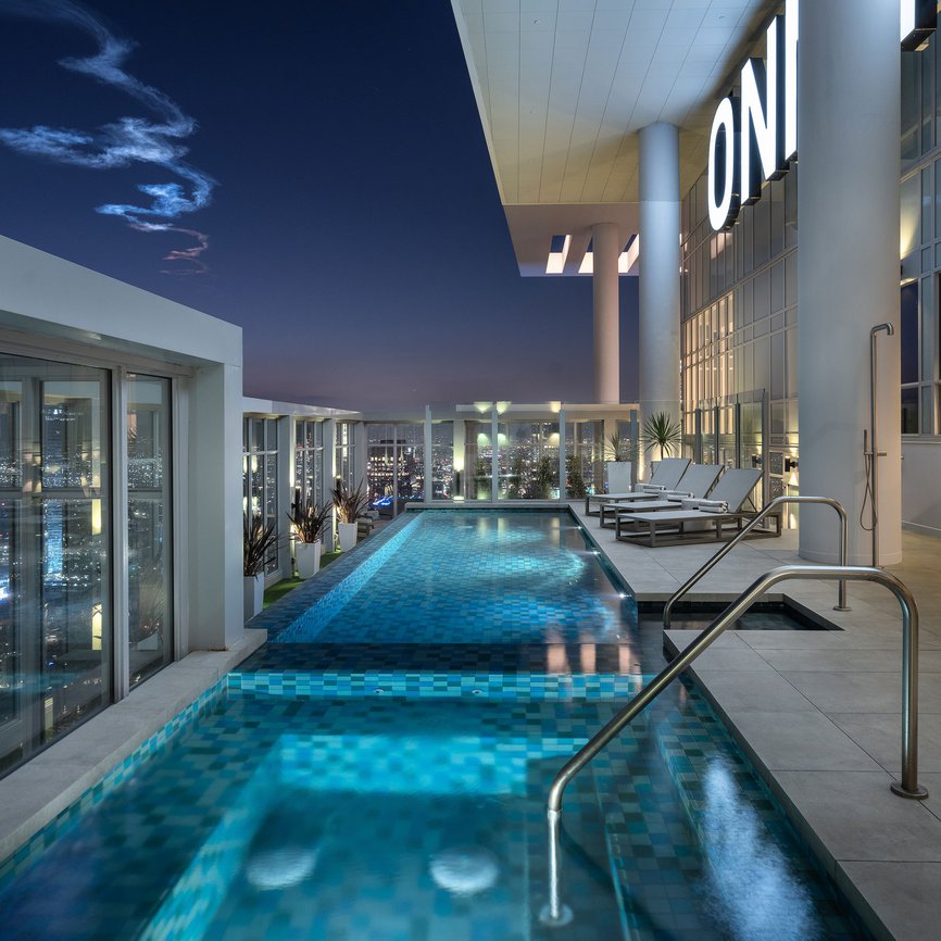 private rooftop patio pool and hot tub with lounge chairs at level south hill penthouse los angeles