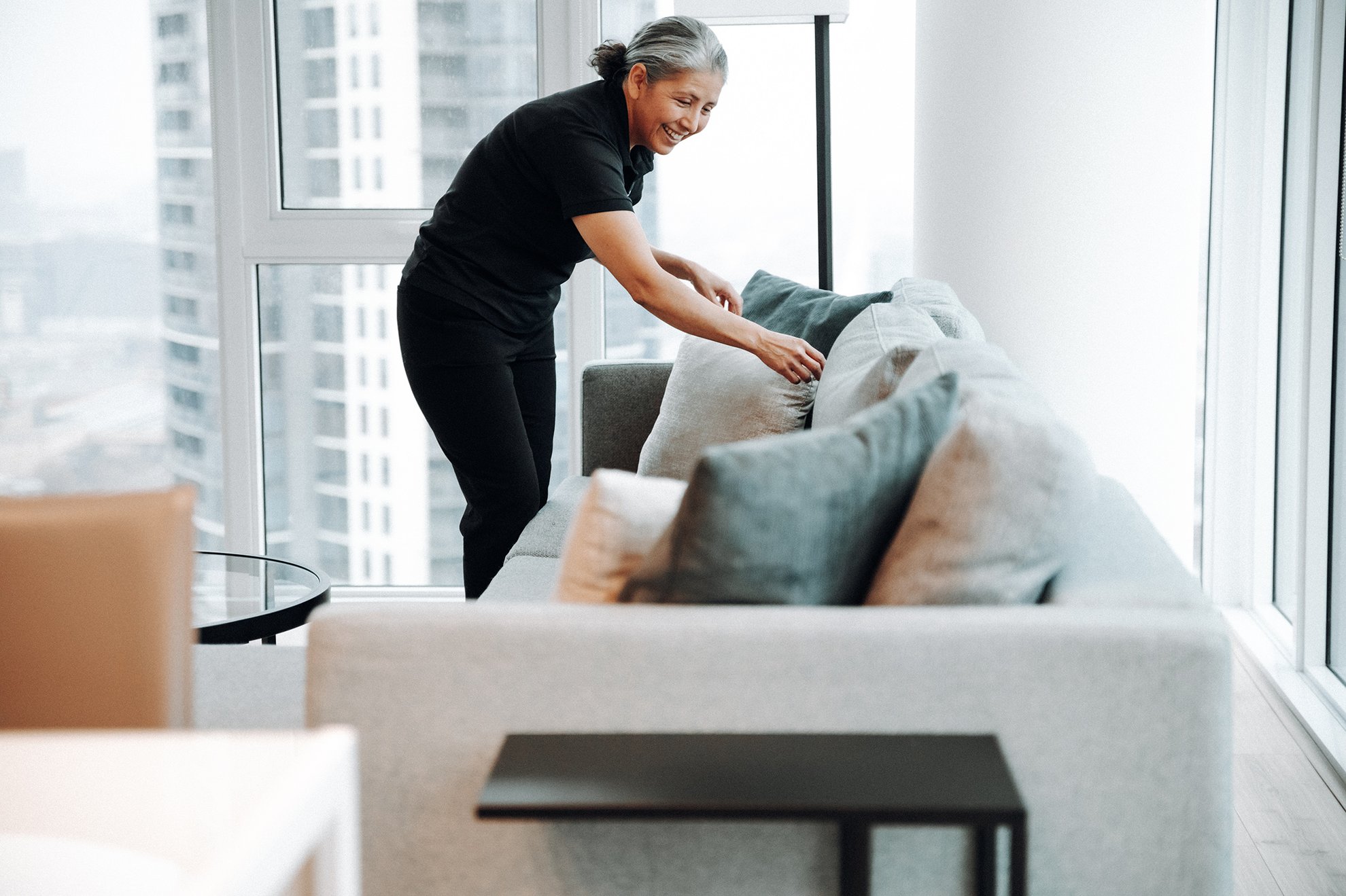 housekeeper cleaning the suite at level hotels and furnished suite