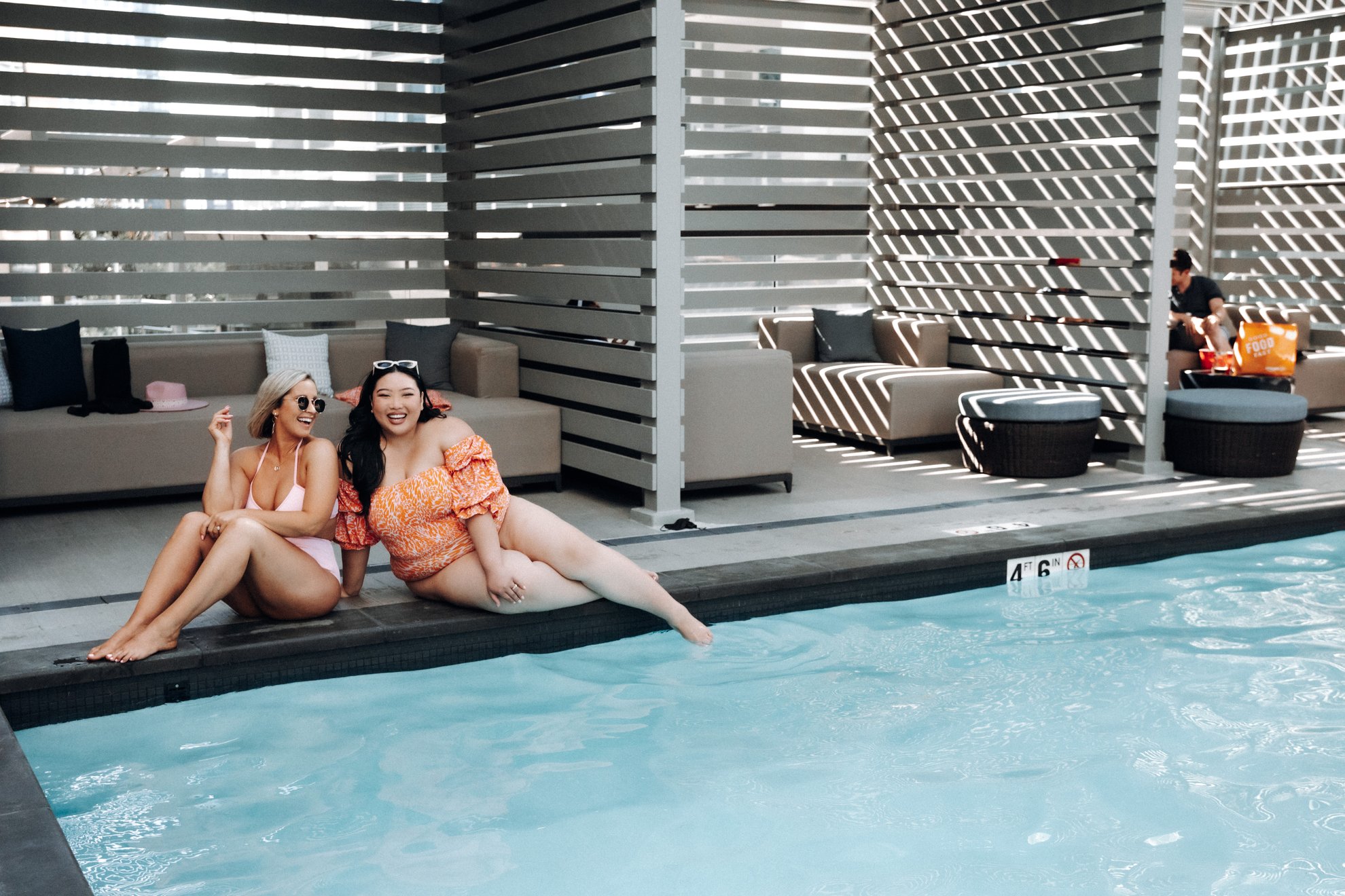 two girls enjoy the outdoor pool at level seattle south lake union
