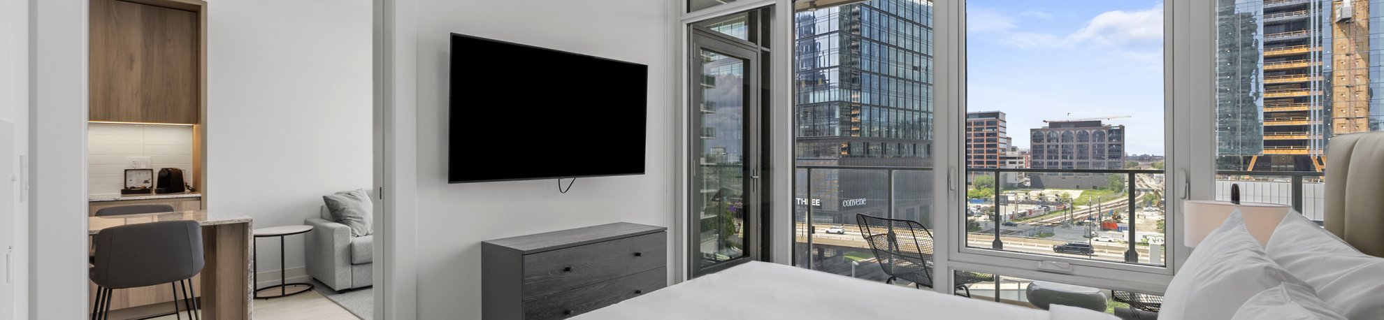 bedroom with the balcony and wall mounted tv at level chicago fulton market