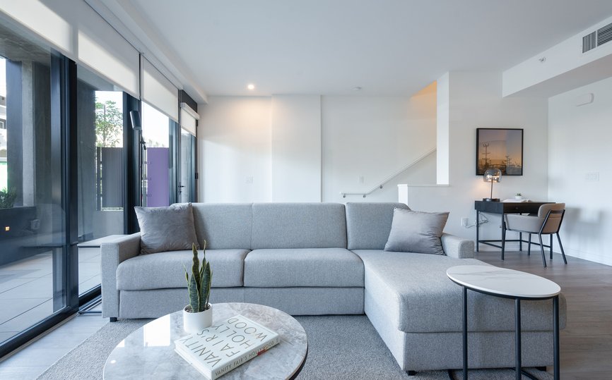 spacious functional living spaces with sofa and coffee table at level hollywood los angeles