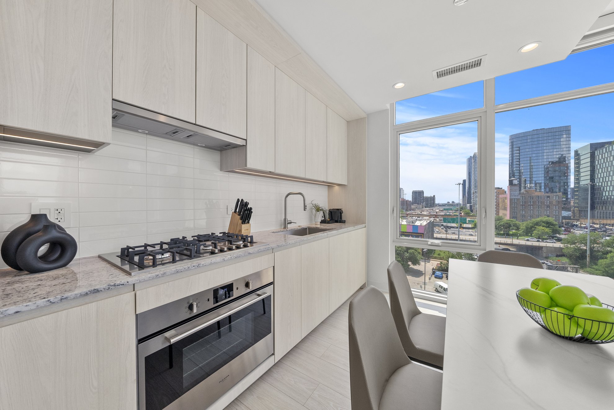 kitchen area at level fulton market looking to beautiful chicago view from three bedroom suite