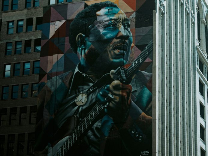 Murial of jazz artist with guitar on building in Chicago