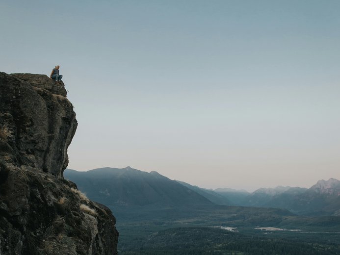 Person sitting on Rattlesnake Ledge in Pacific Northwest