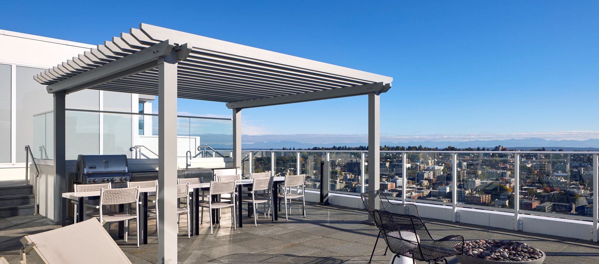 large outdoor rooftop deck with seattle city view, oudoor furnitures, barbecure grill at level seattle penthouse south lake union.jpg