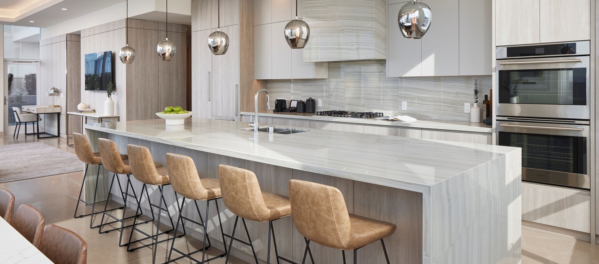 modern kitchen at penthouse level seattle features long island, stainless steel appliances, dining area.jpg