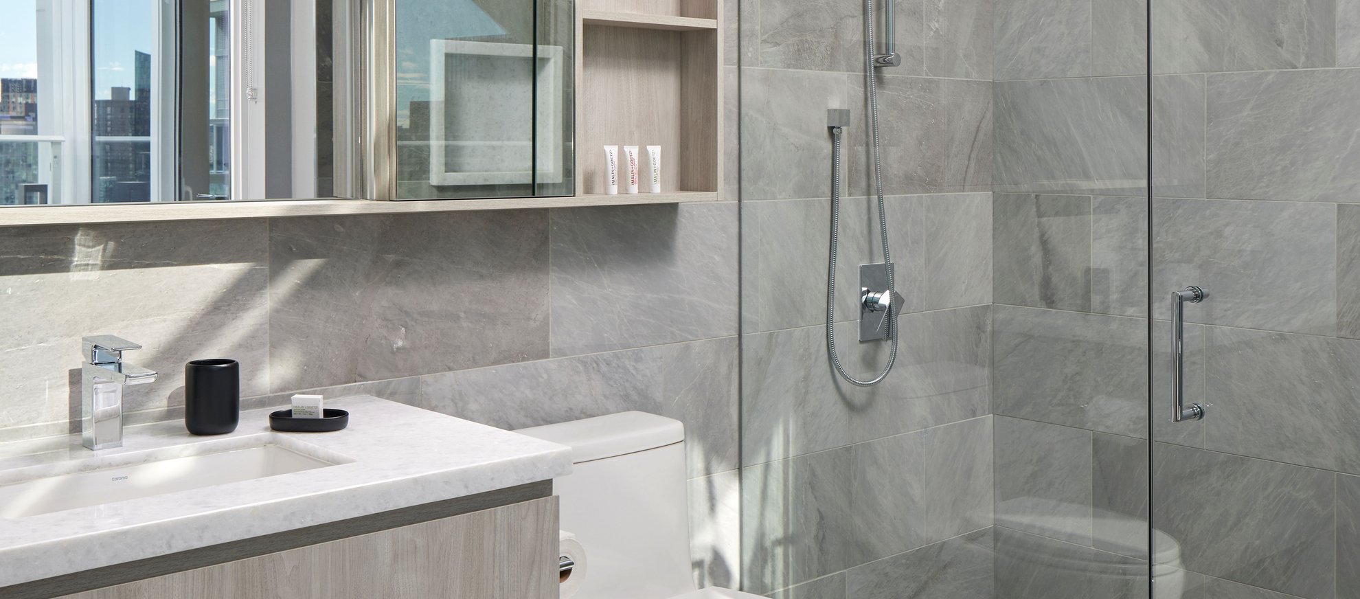 modern luxury bathroom with glass shower and rainfall shower head at the penthouse level south lake union.jpg