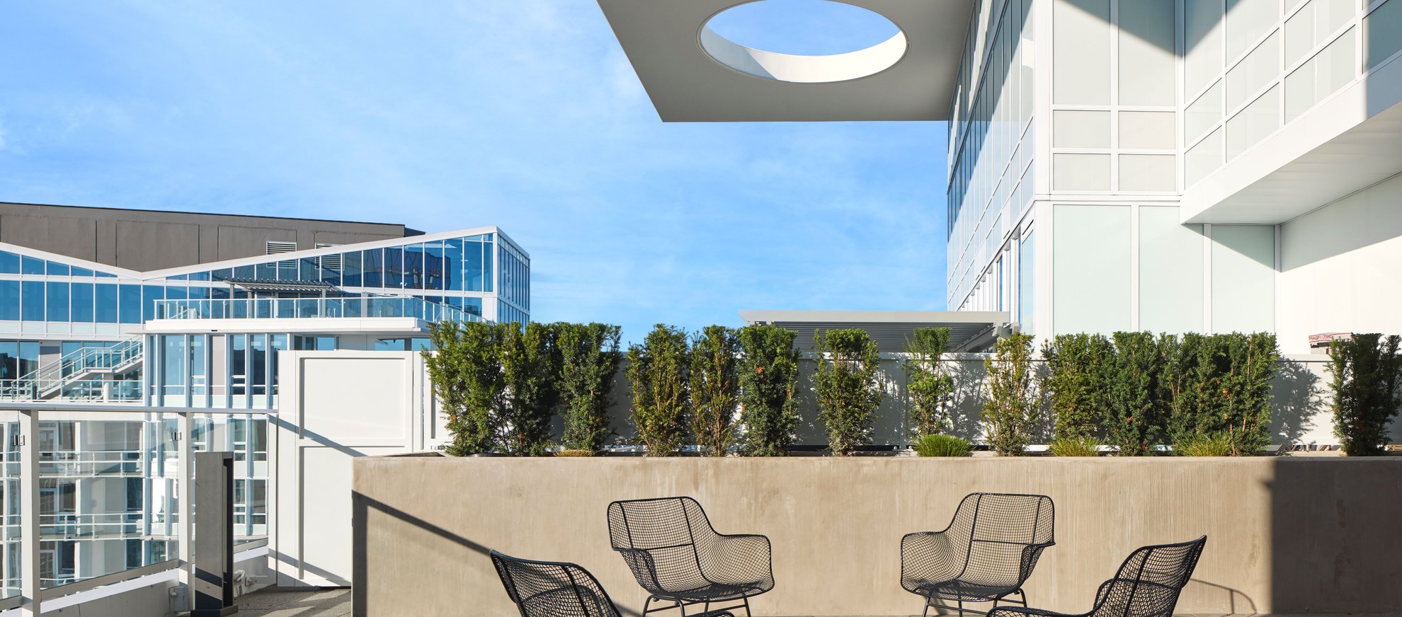modern outdoor setting on rooftop patio of penthouse at level seattle south lake union with firepit, space needle city view.jpg