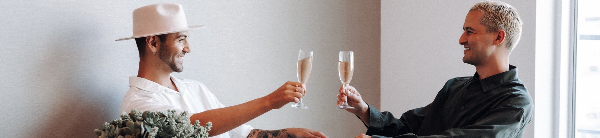 men sitting down at dining table with wine in hand
