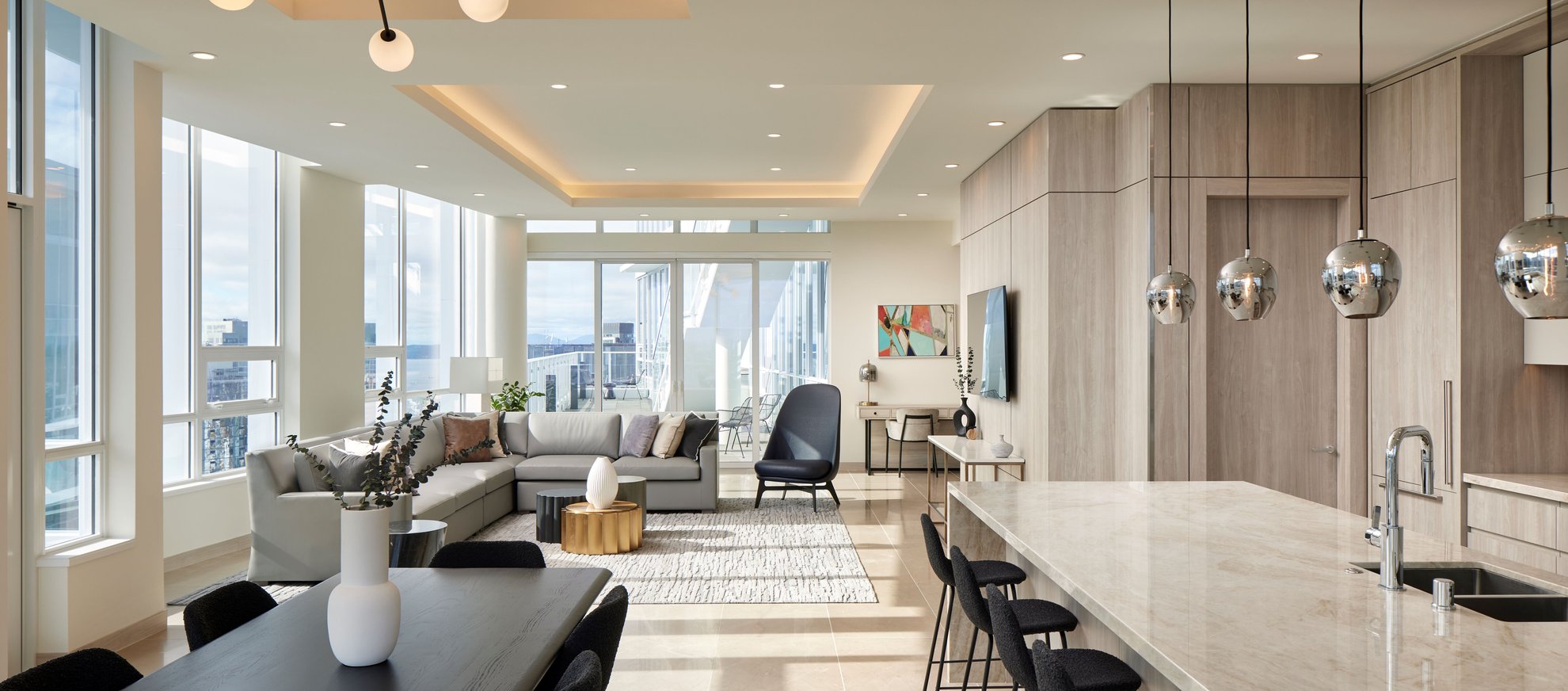open concept kitchen and living area with a seattle city view at the penthouse level south lake union.jpg