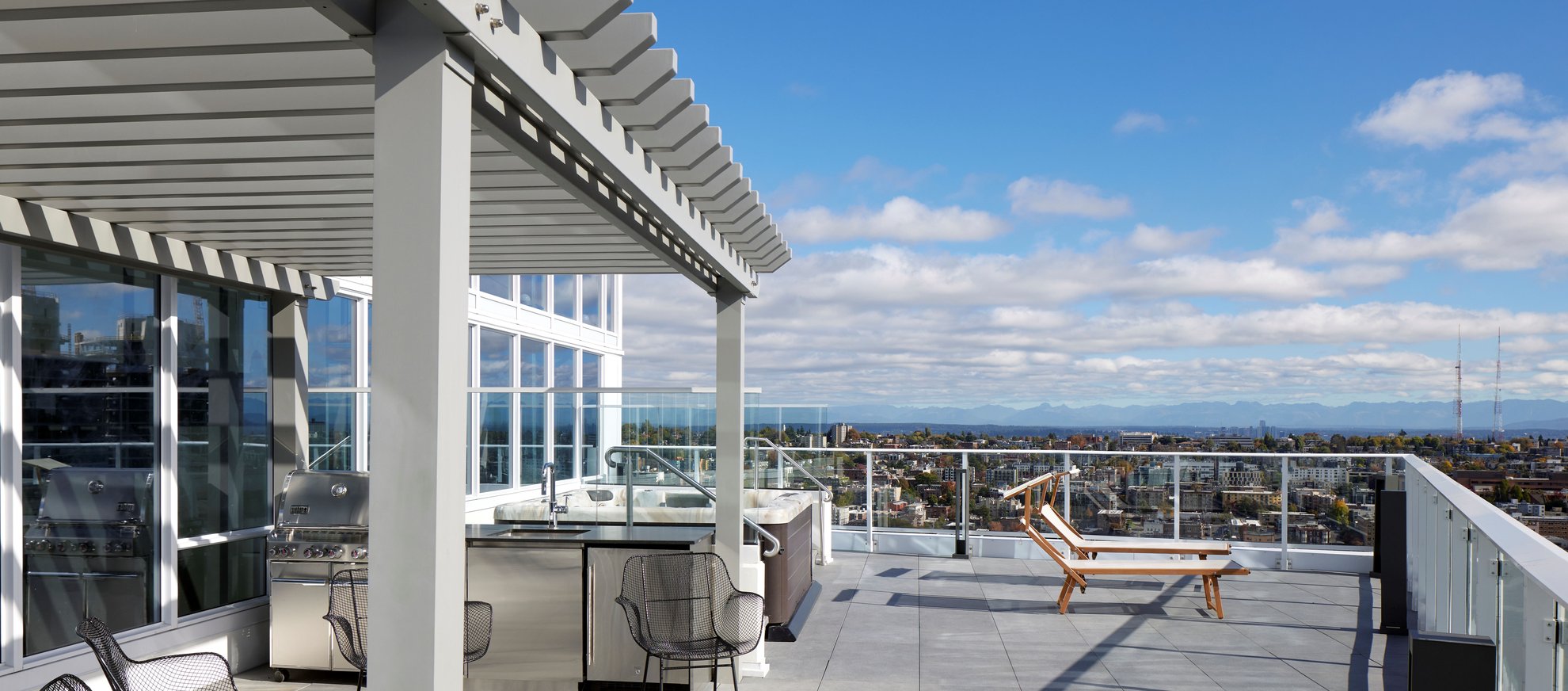 spacious outdoor rooftop terrace with seating options, outdoor kitchen, city view at the penthouse level seattle south lake union.jpg