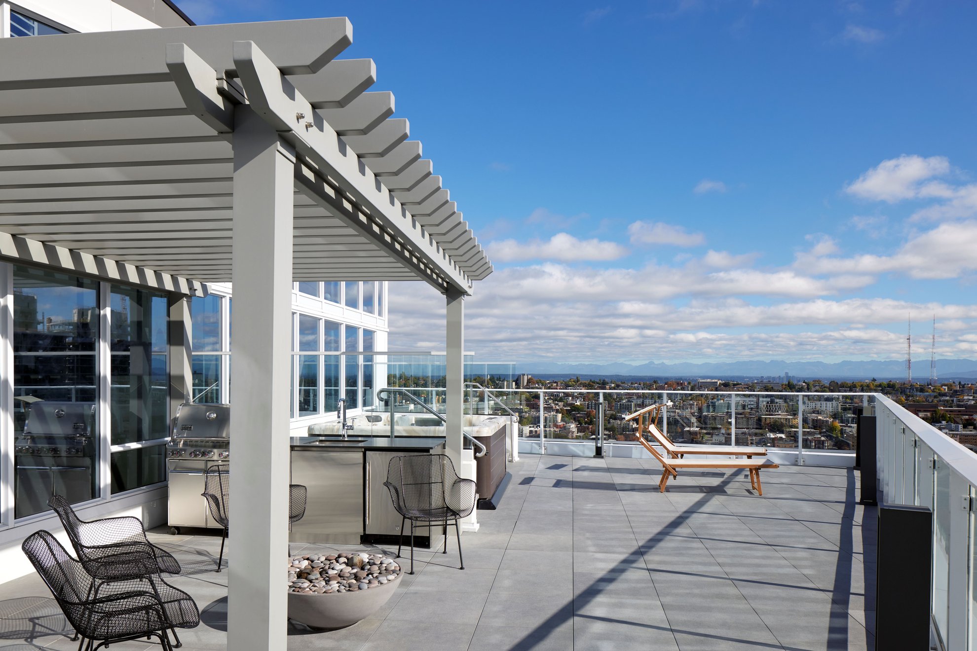 spacious outdoor rooftop terrace with seating options, outdoor kitchen, city view at the penthouse level seattle south lake union.jpg