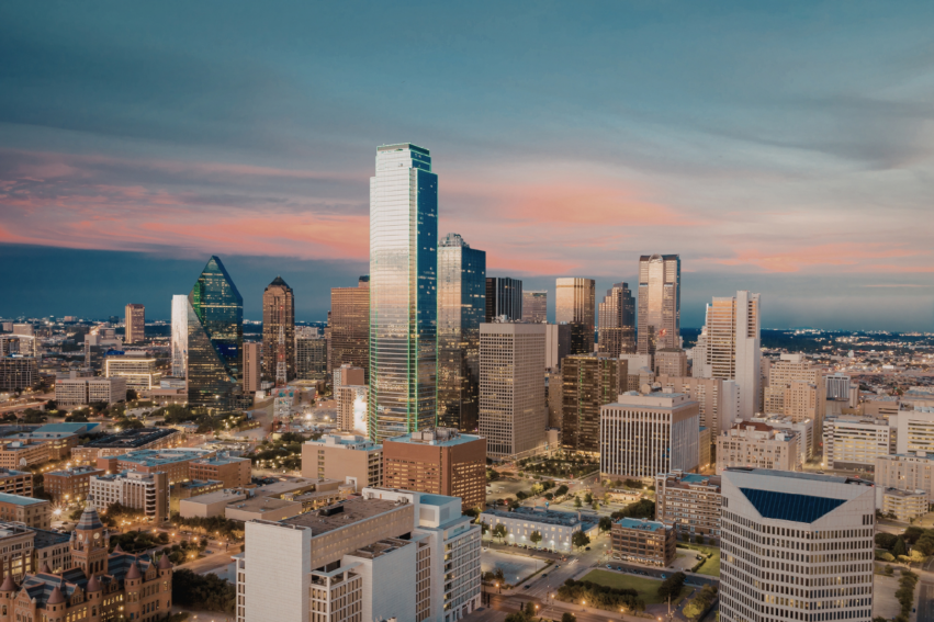 Aerial view of a city skyline at sunset, featuring tall modern skyscrapers, illuminated buildings, and a mix of architectural styles under a partly cloudy sky.